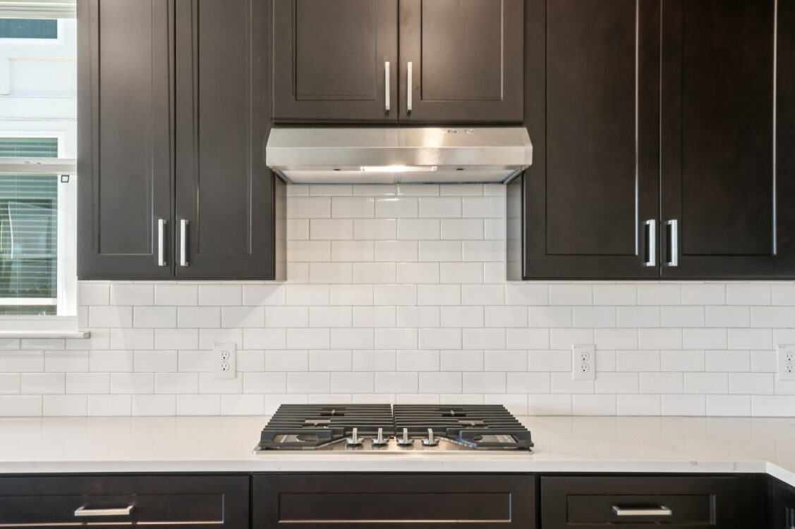 11224 Zip Cochise Way Manor, TX 78653 - Photo 21 of 40 a kitchen with a stove and a microwave