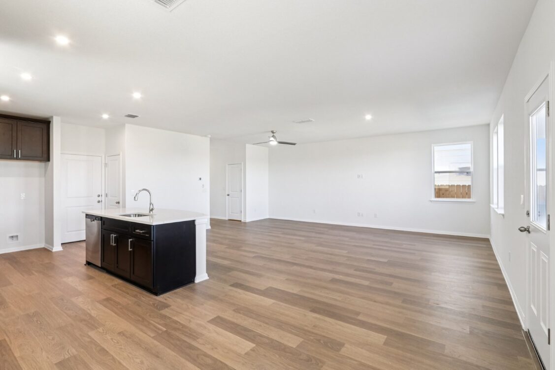 11224 Zip Cochise Way Manor, TX 78653 - Photo 22 of 40 a view of an empty room with wooden floor and a window