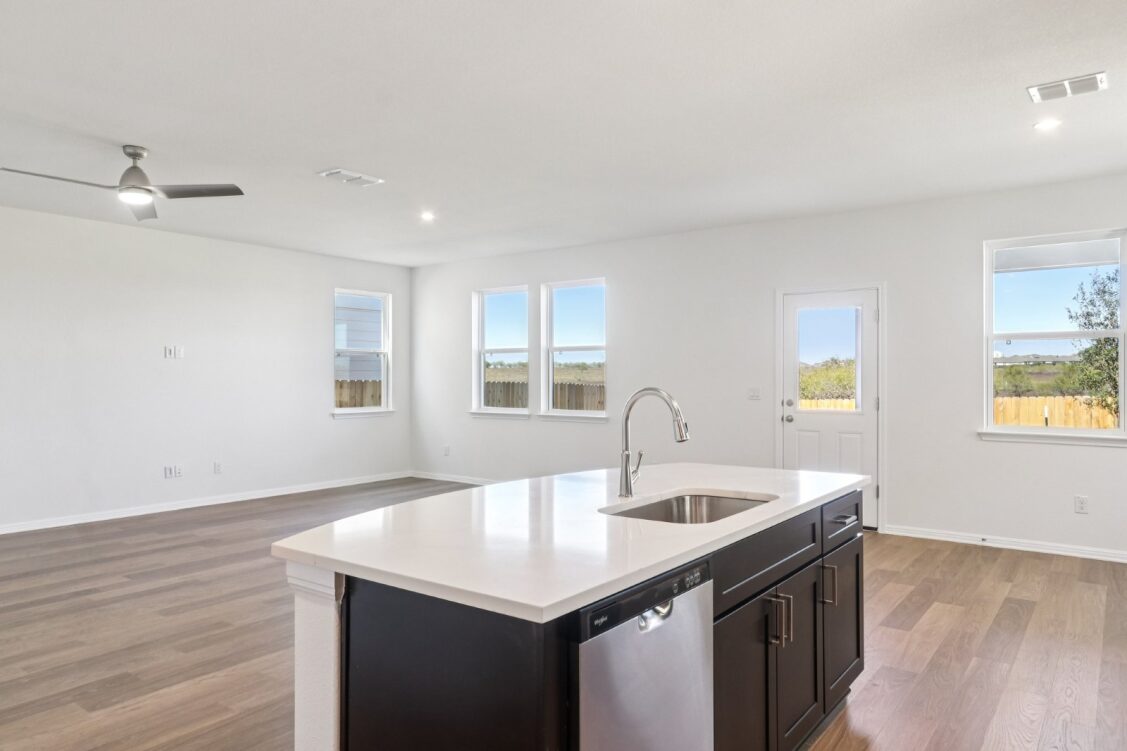 11224 Zip Cochise Way Manor, TX 78653 - Photo 23 of 40 a kitchen with a sink cabinets and wooden floor