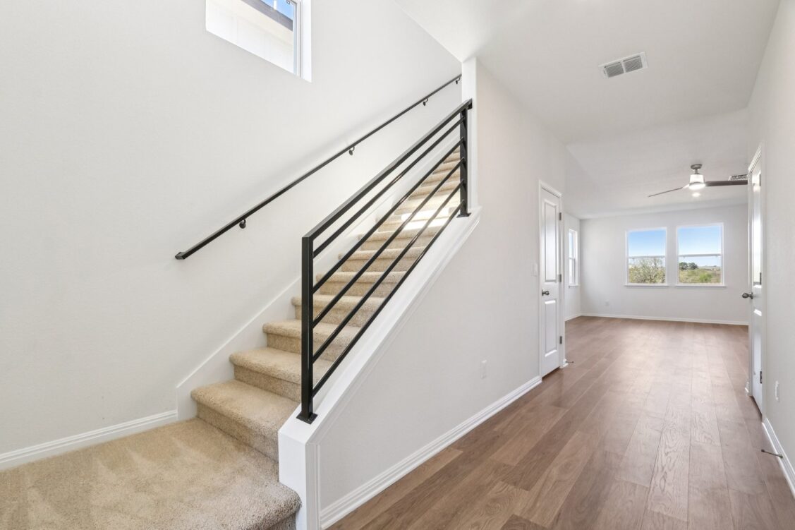11224 Zip Cochise Way Manor, TX 78653 - Photo 26 of 40 a view of a hallway with wooden floor and staircase