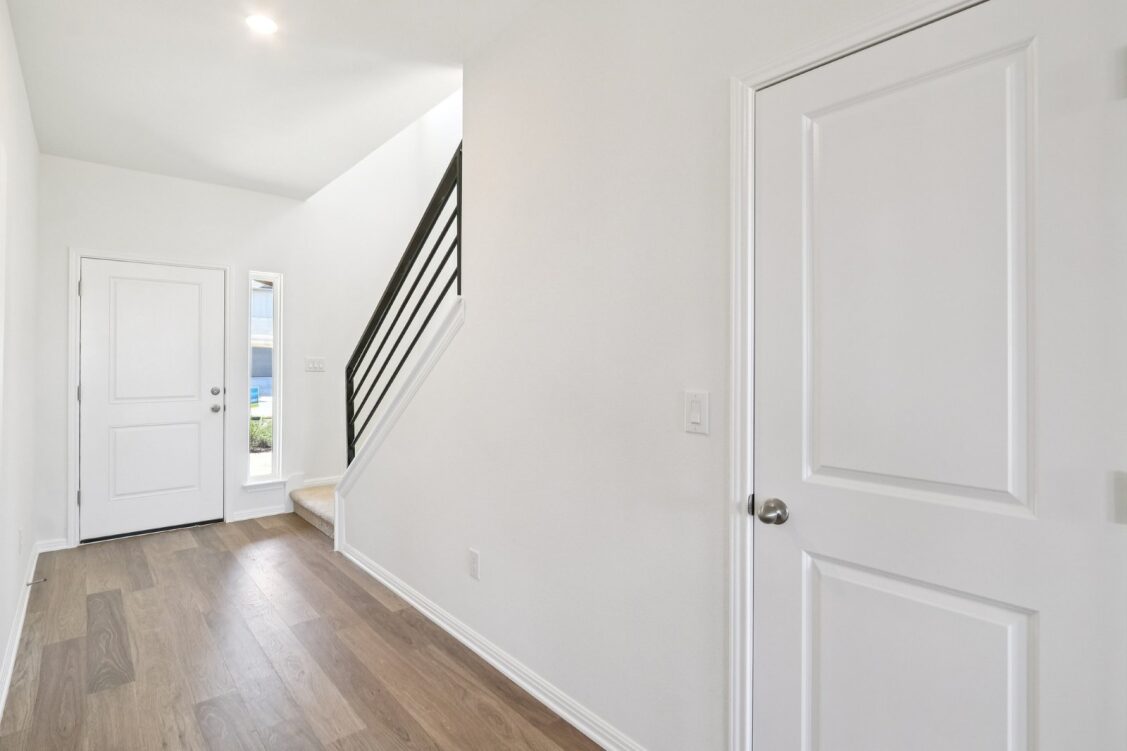11224 Zip Cochise Way Manor, TX 78653 - Photo 12 of 40 a view of a hallway with wooden floor and entryway