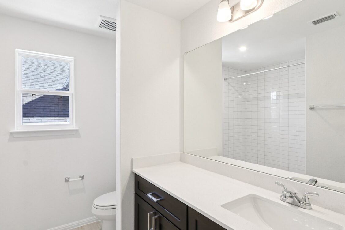 11224 Zip Cochise Way Manor, TX 78653 - Photo 36 of 40 a bathroom with a sink toilet vanity and shower