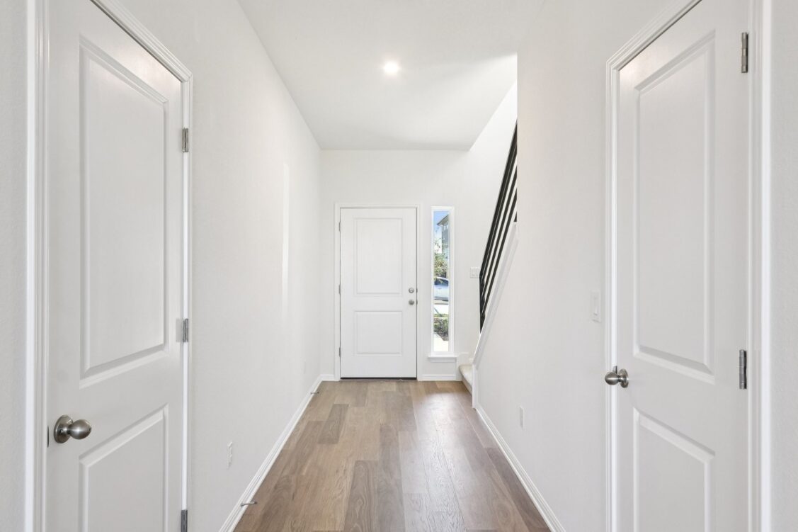 11224 Zip Cochise Way Manor, TX 78653 - Photo 13 of 40 a view of a hallway with wooden floor and entryway