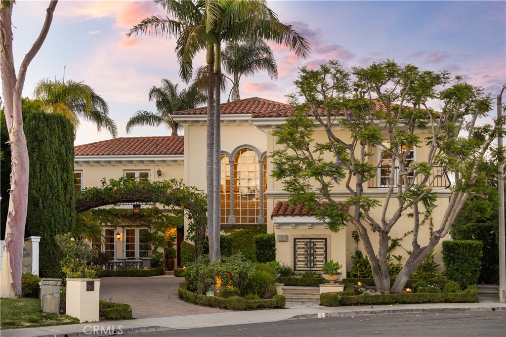 a front view of a building with palm trees