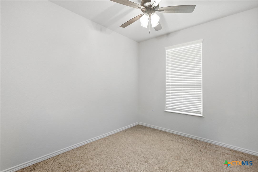 3201 Hedwig Street Killeen, TX 76549 - Photo 21 of 38 an empty room with a window and a fan