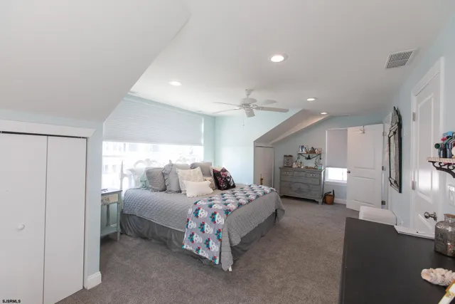 a bedroom with double bed and a chandelier