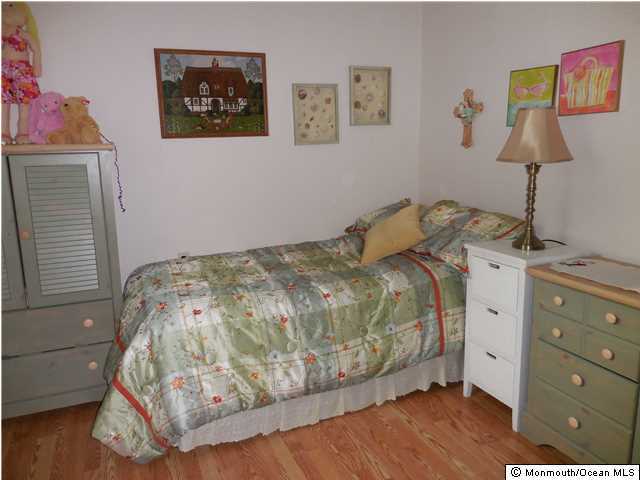 12 Phillips Road Brick, NJ 08724 - Photo 11 of 19 a bedroom with a bed and a lamp on dresser