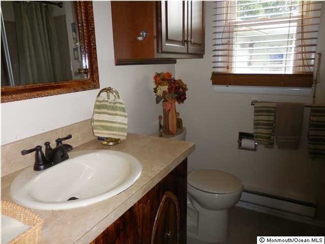 12 Phillips Road Brick, NJ 08724 - Photo 12 of 19 a bathroom with a sink a toilet and mirror