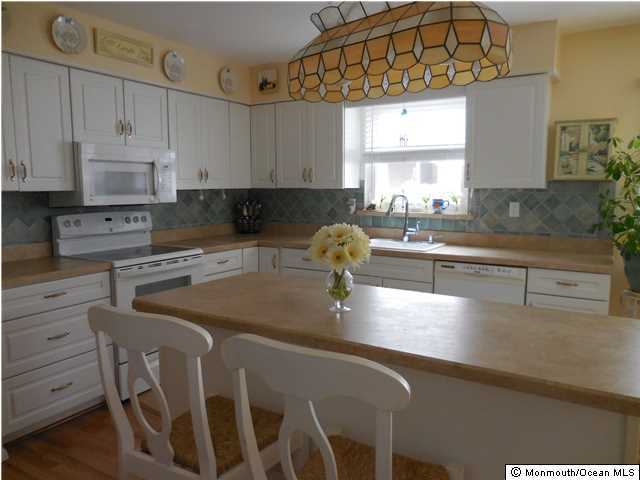 12 Phillips Road Brick, NJ 08724 - Photo 3 of 19 a kitchen with stainless steel appliances granite countertop a sink a stove counter space and cabinets