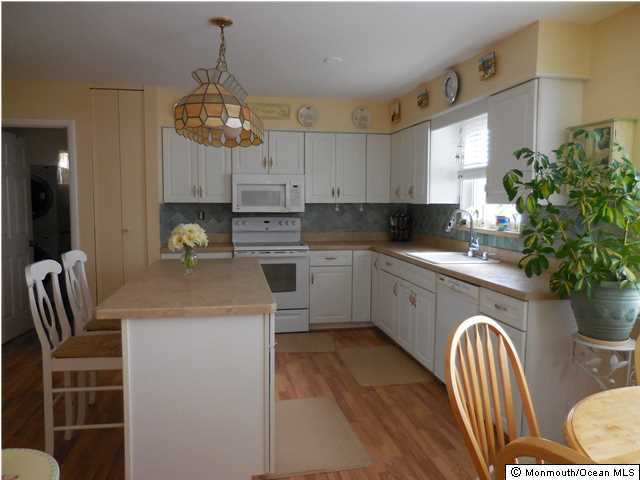 12 Phillips Road Brick, NJ 08724 - Photo 4 of 19 a kitchen with stainless steel appliances granite countertop a sink a stove a refrigerator a dining table and chairs