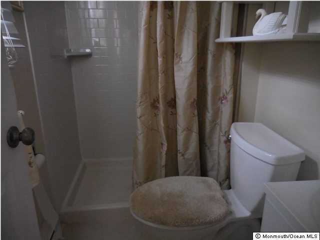 12 Phillips Road Brick, NJ 08724 - Photo 10 of 19 a white toilet sitting next to a shower