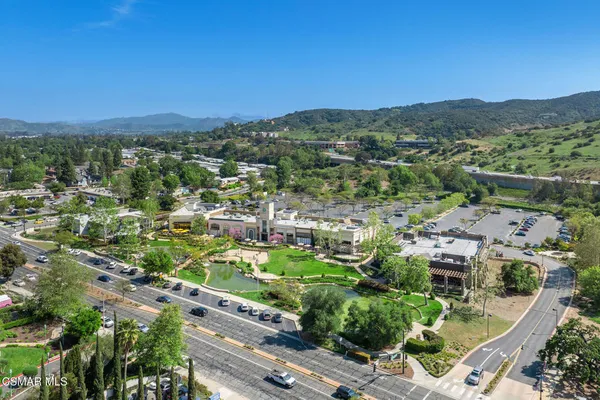 an aerial view of residential houses with outdoor space and trees