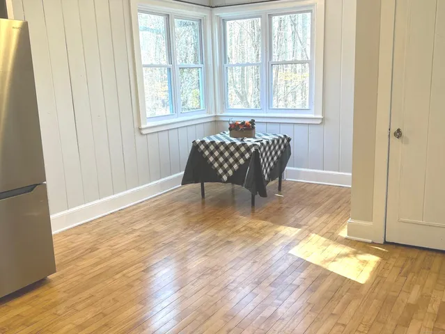 a room with wooden floor and windows