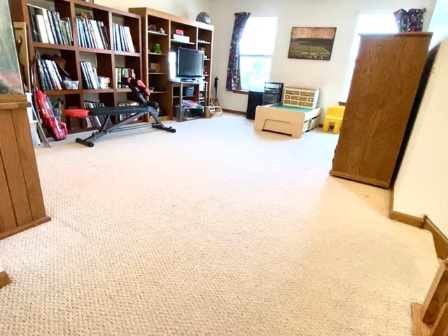 a bedroom with furniture and a large window