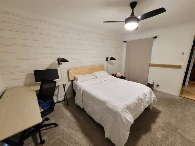 a bedroom with a bed and a chair
