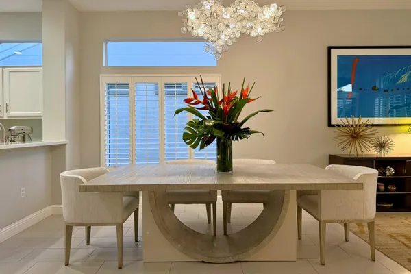 a view of a dining room with furniture and chandelier