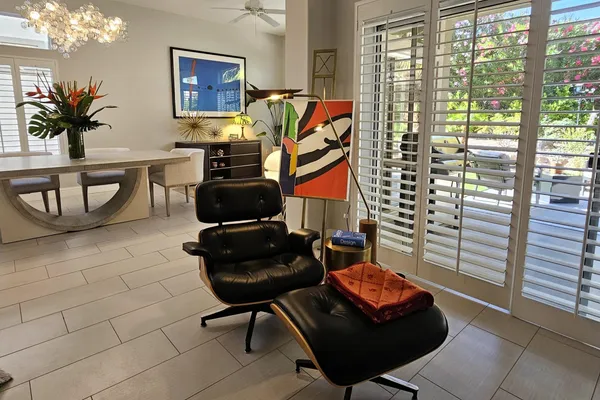 a living room with furniture and a potted plant