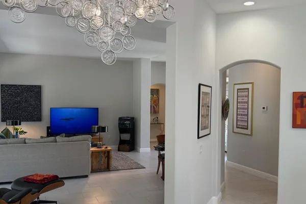 a living room with furniture and a chandelier
