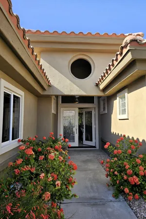 front view of a house with a flower garden