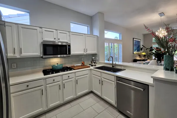 a kitchen with a sink stove and microwave