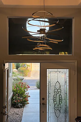 a living room with fireplace furniture and a large window
