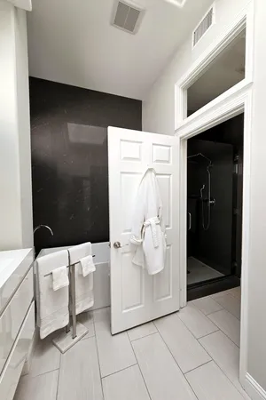 a bathroom with a glass shower door