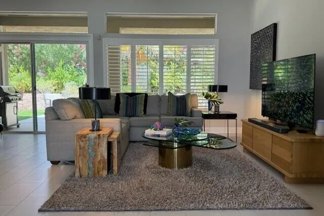 a living room with furniture and a large window