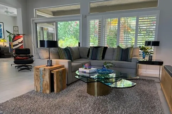 a living room with furniture and a large window