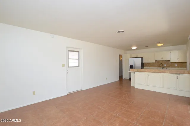 a view of a kitchen with white cabinets