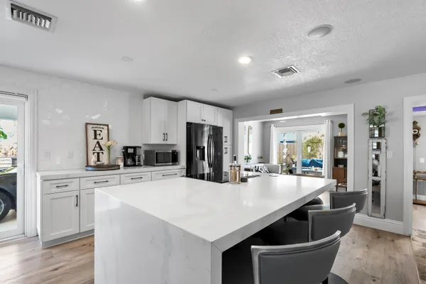a kitchen with refrigerator and window