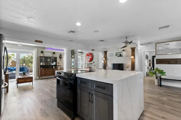 a kitchen with sink stove and cabinets