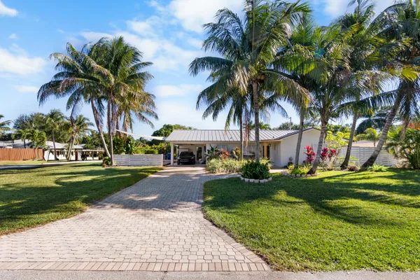 a front view of a house with a garden and patio