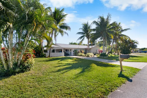 a view of a house with swimming pool and a yard