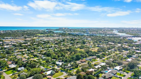 an aerial view of residential houses with city view
