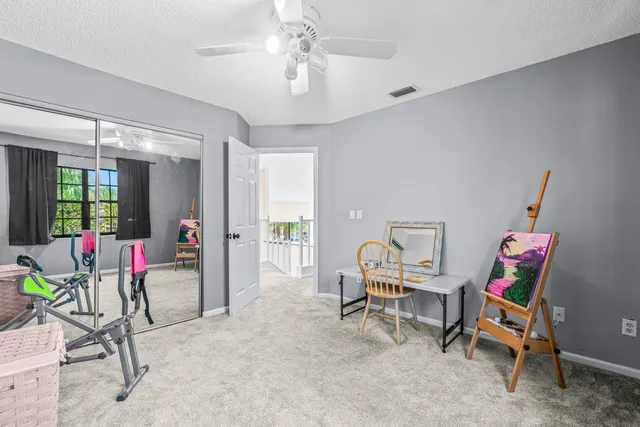 a bedroom with a flat screen tv on the dresser and a flat screen tv