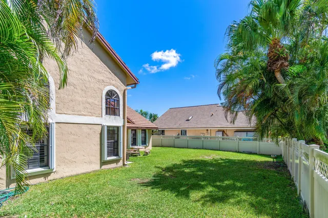 a view of a backyard with plants and a patio