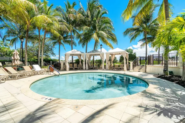 a dining room with furniture a chandelier and wooden floor