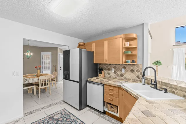 a kitchen with a refrigerator and a sink