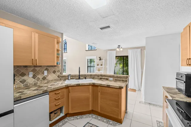 a kitchen with stainless steel appliances a sink and a microwave