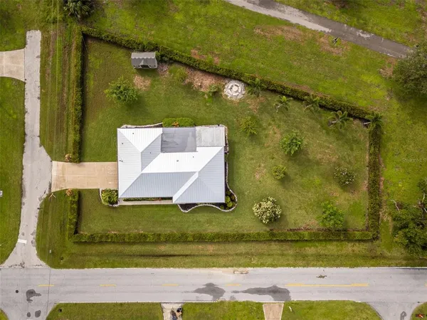 an aerial view of a residential houses with outdoor space