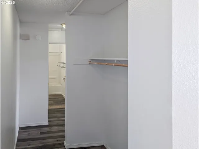 a view of hallway with stairs and wooden floor