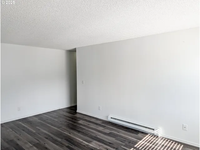 a view of room with wooden floor