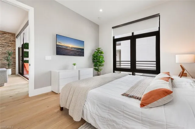 a bedroom with a large bed and a flat screen tv