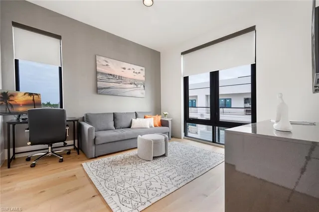 a living room with furniture and wooden floor