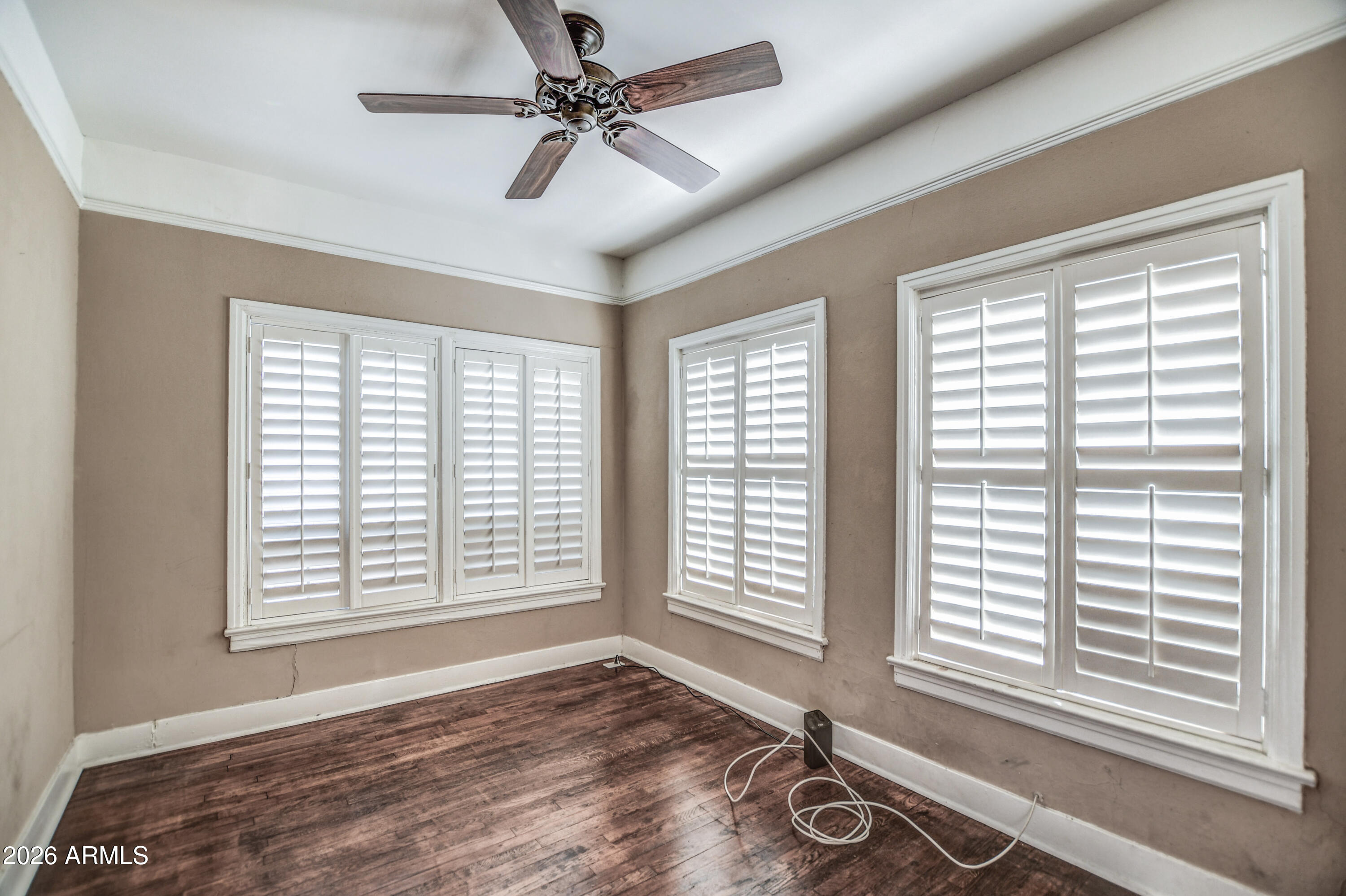 384 East Windsor Avenue Phoenix, AZ 85004 - Photo 13 of 42 a view of an empty room with a window and wooden floor