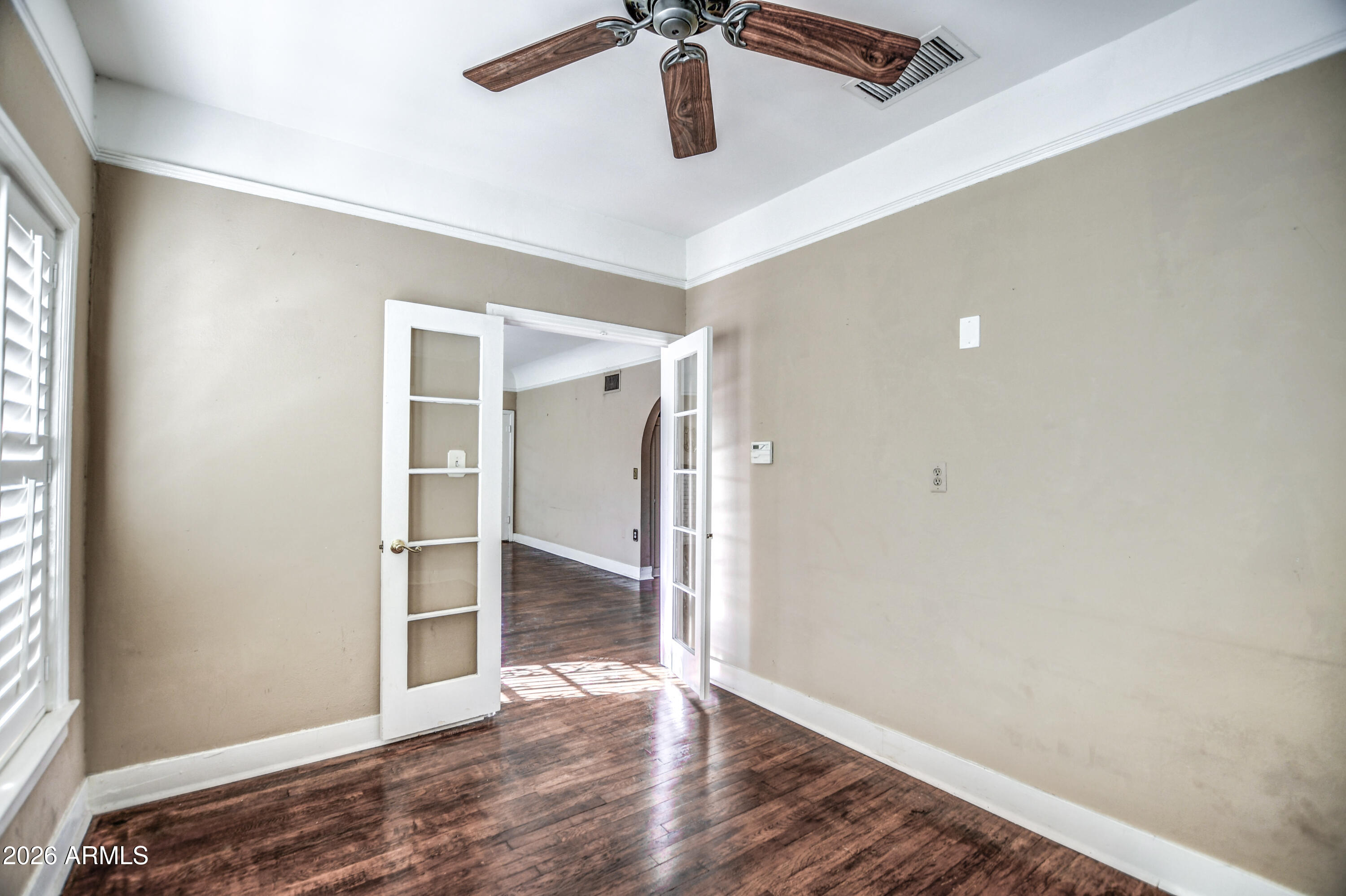 384 East Windsor Avenue Phoenix, AZ 85004 - Photo 14 of 42 a view of empty room with wooden floor and fan