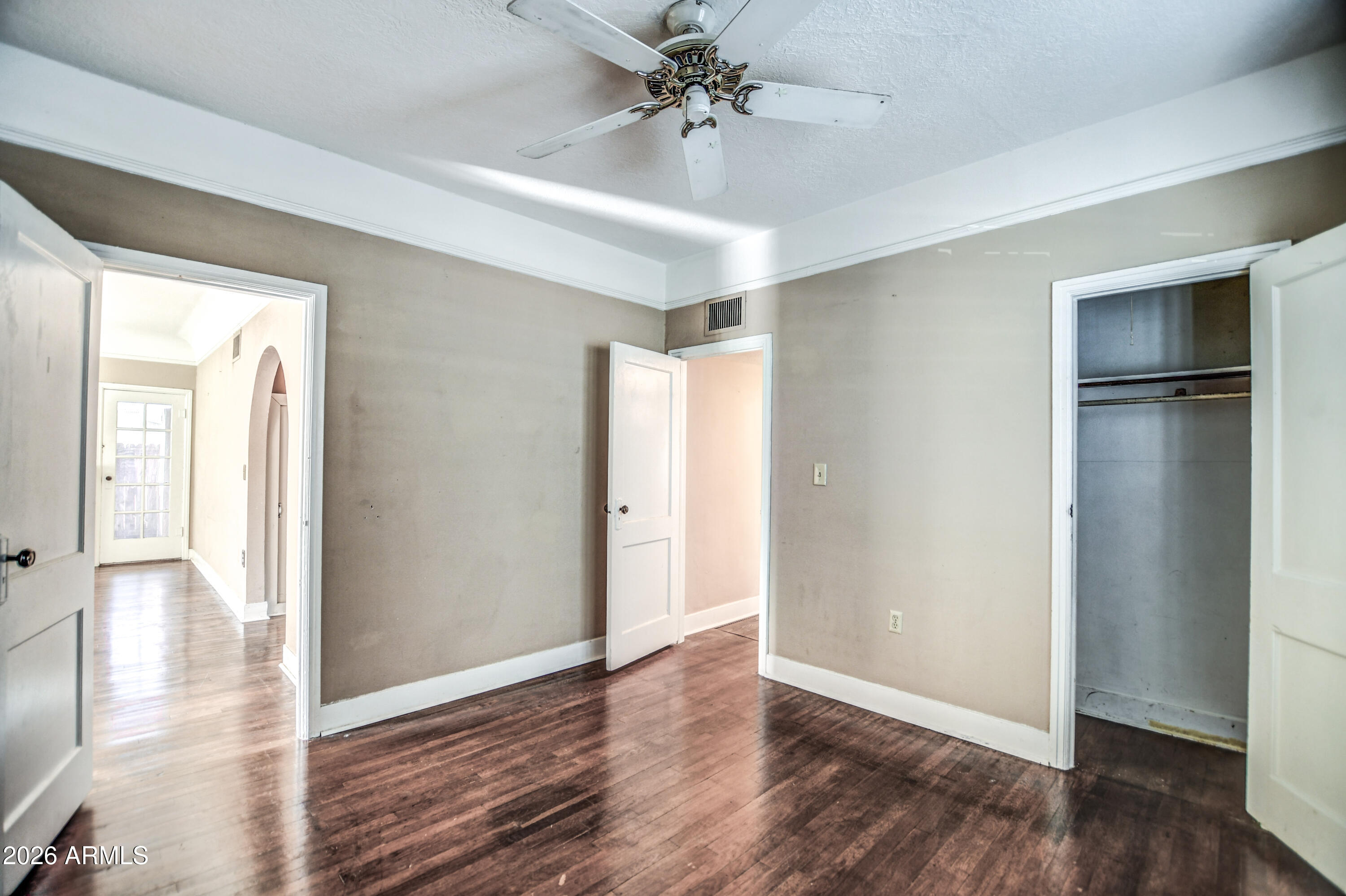 384 East Windsor Avenue Phoenix, AZ 85004 - Photo 16 of 42 an empty room with wooden floor closet and windows