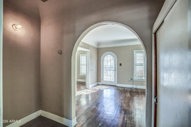 a view of empty room with wooden floor