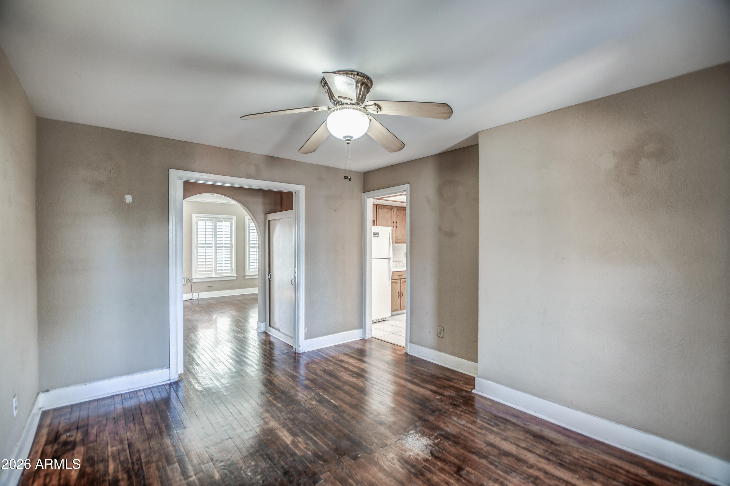 384 East Windsor Avenue Phoenix, AZ 85004 - Photo 18 of 42 wooden floor in an empty room with a window