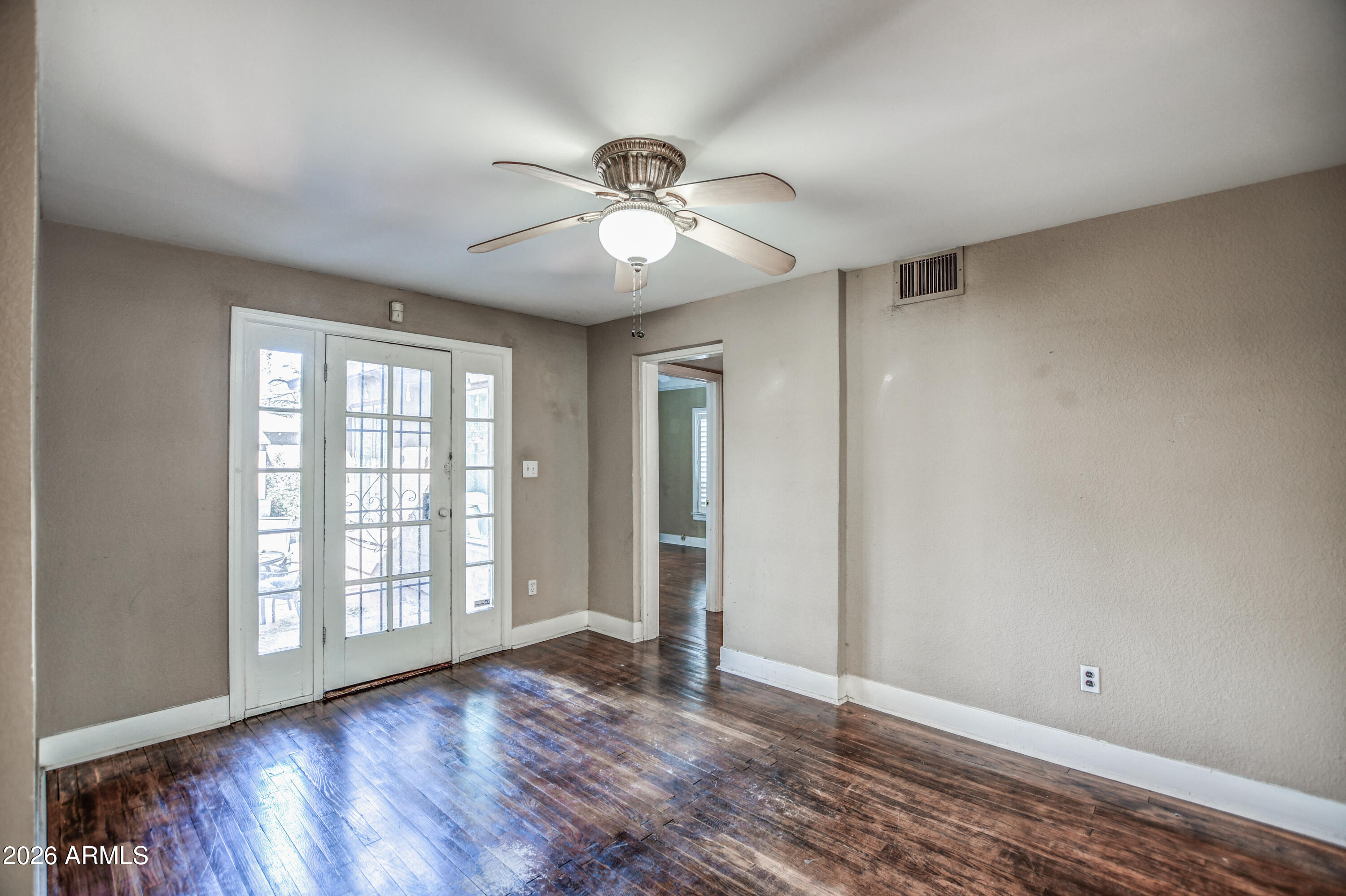 384 East Windsor Avenue Phoenix, AZ 85004 - Photo 20 of 42 a view of an empty room with window and wooden floor